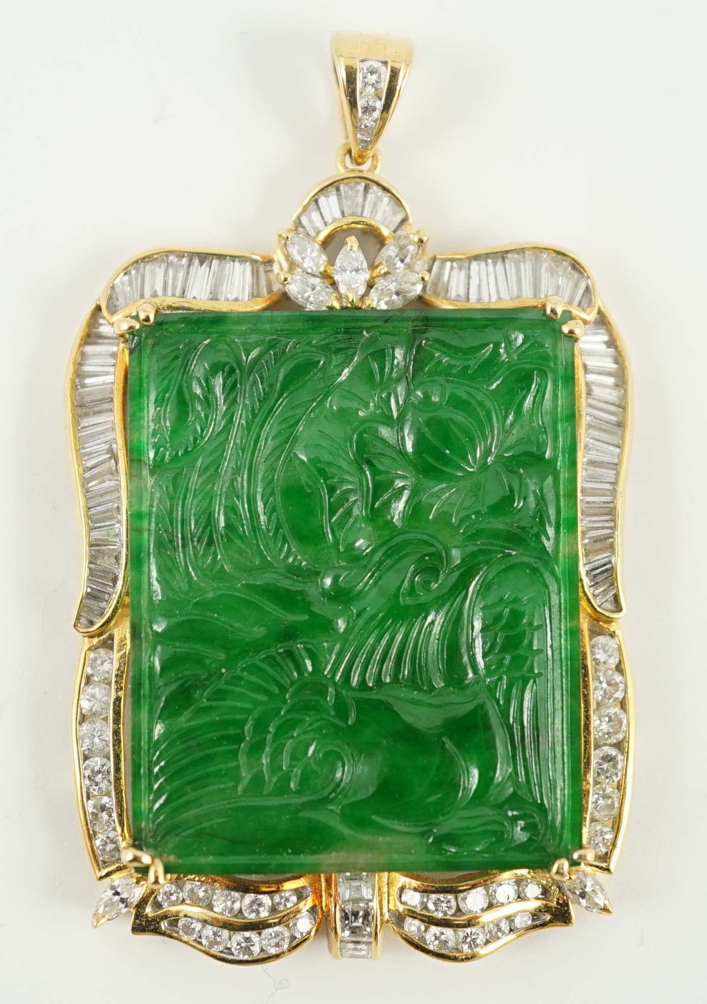 A late 20th century gold (tests as 18ct) mounted jade pendant, with round, marquise and trapeze cut diamond set border